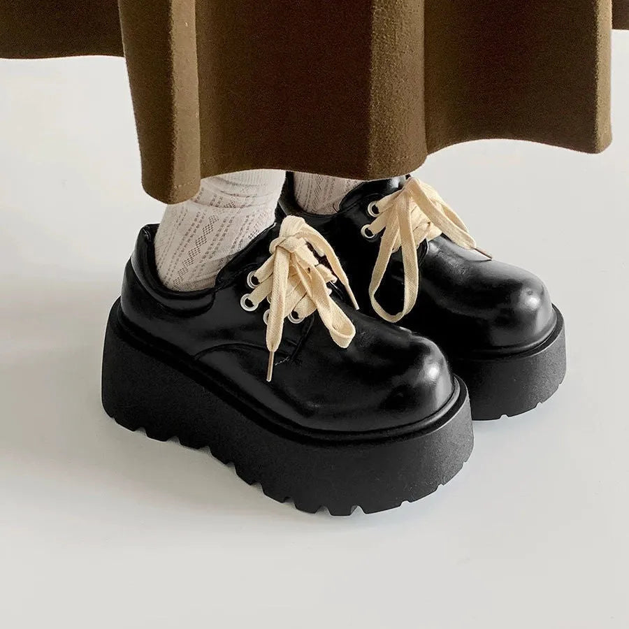 Women's matte black retro ankle boots with a thick rubber sole and buckle fastening on the side.
