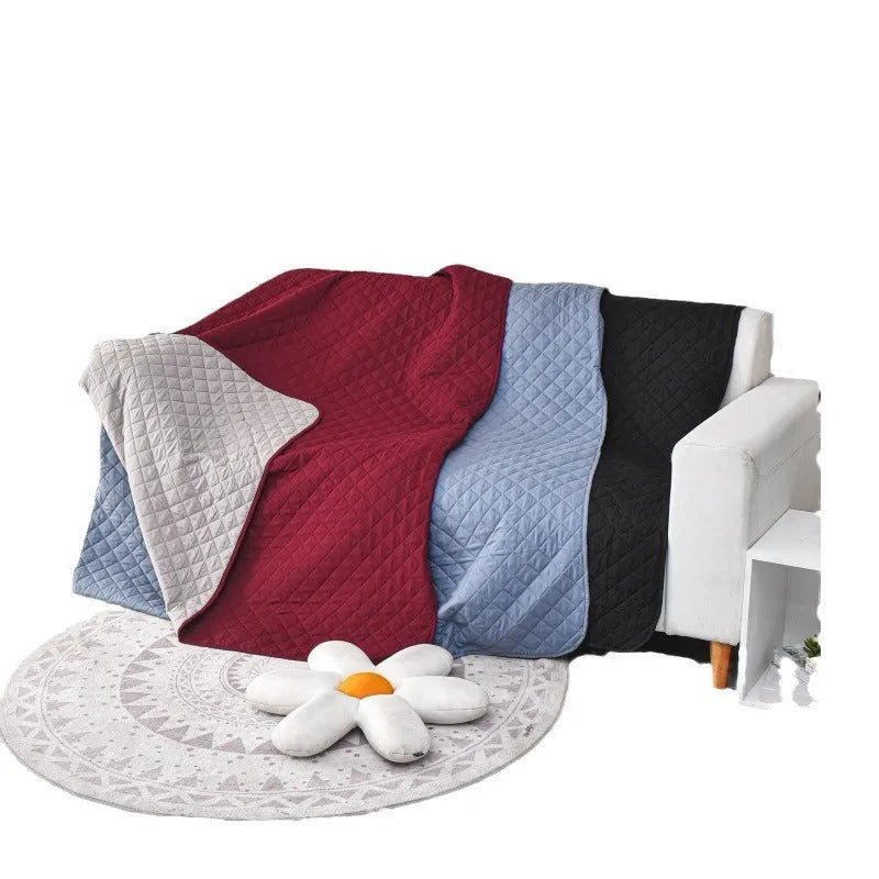 Reversible dog blanket and sofa cover in waterproof washable fabric, showing two colour sides.