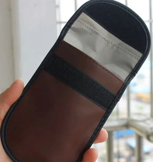Black microfiber Faraday cage bag for blocking car key and RFID signals, size 13.5cm by 9.5cm.