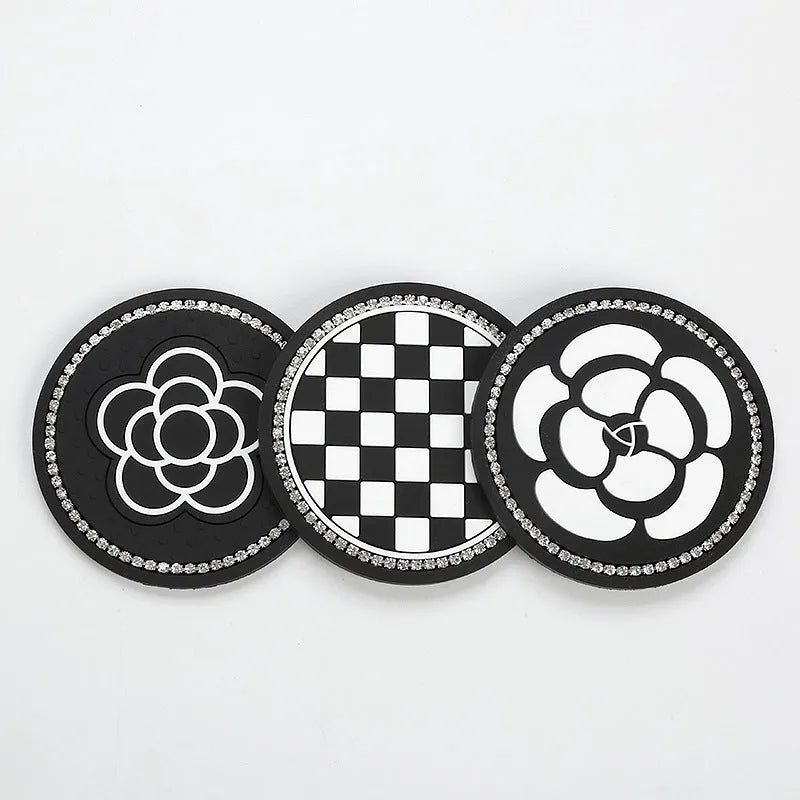 PVC car cup holder mat in black and white checkerboard pattern showing dimensions of 15.2 by 10.1 centimetres