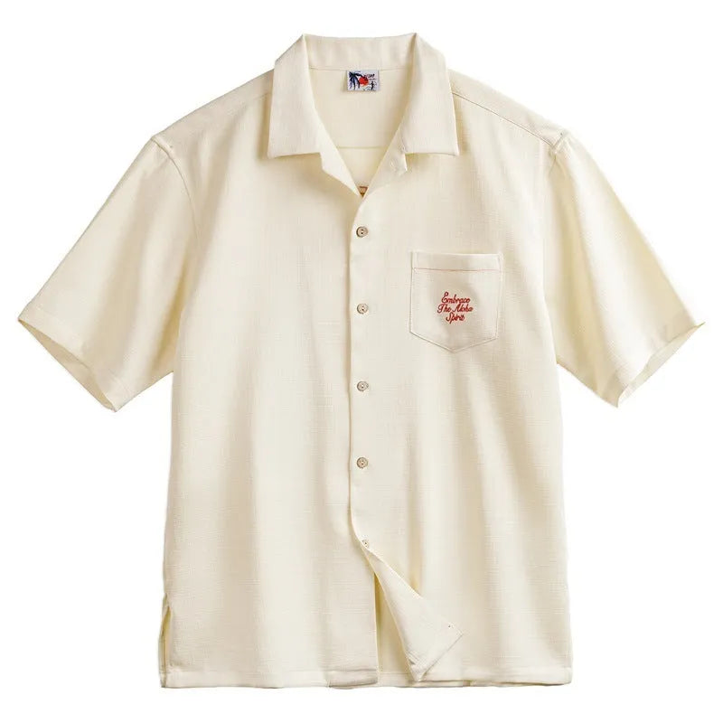 A light apricot men's shirt with a bamboo plant pattern and a relaxed Cuban collar.