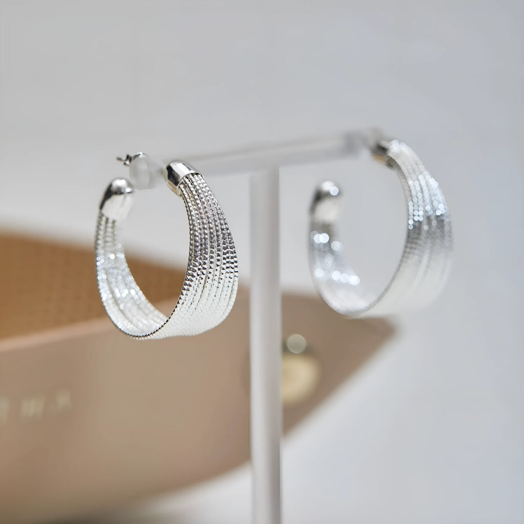 Geometric multi-layer copper earrings with silver or gold electroplated finish, showing stud and clip options