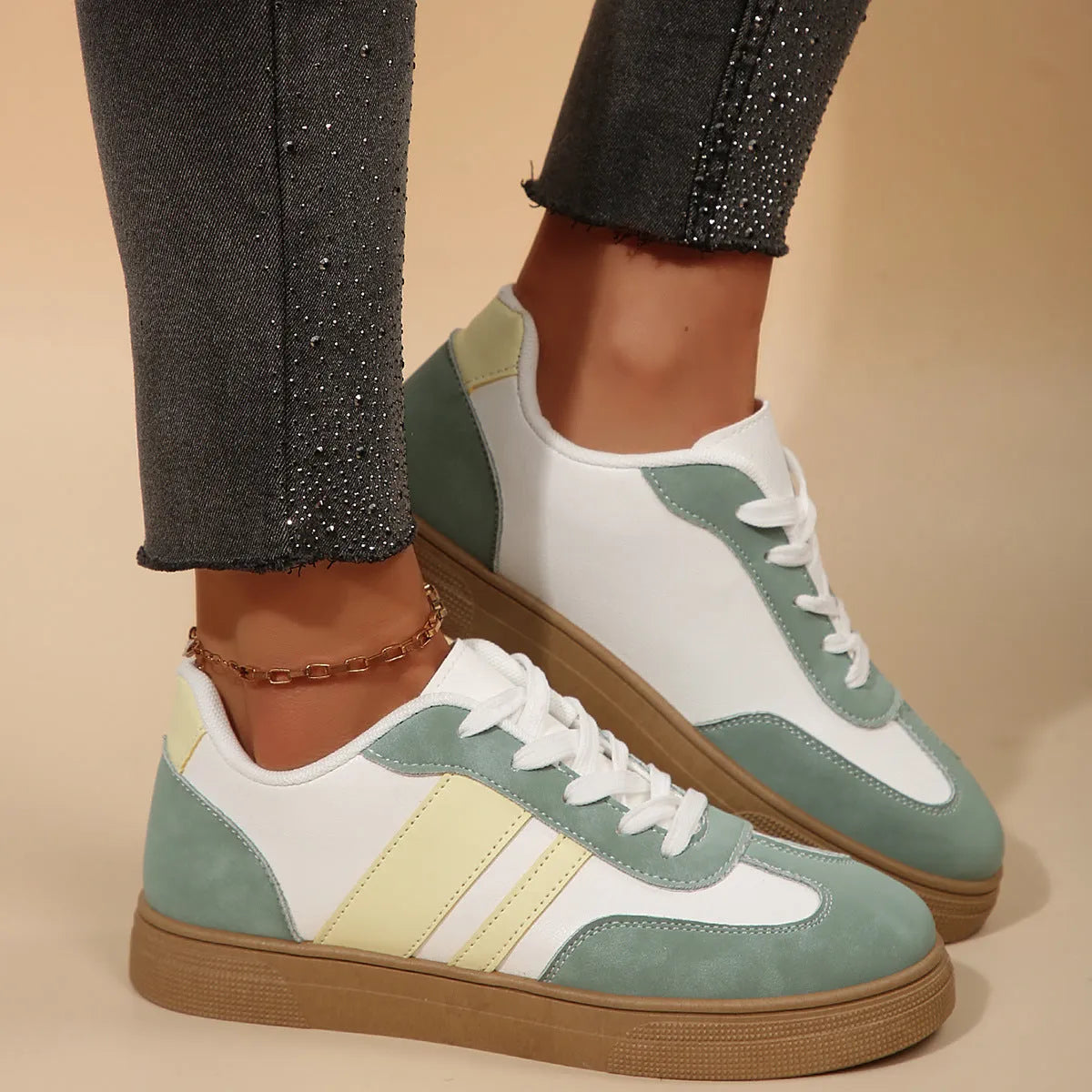 Green women's retro sports pumps with cross straps, a round toe, and a flat rubber sole.