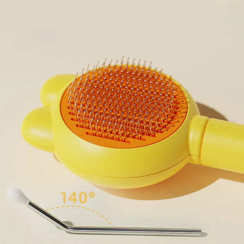 Self-cleaning pet grooming brush with coloured handle and stainless steel comb teeth with rubber tips