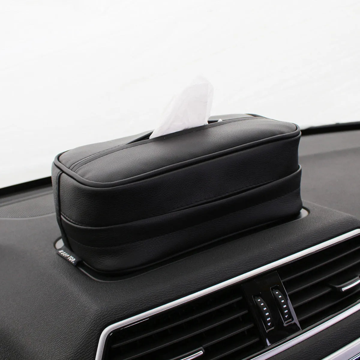 Black leather car hanging storage box with open top, shown next to a beige medium-sized version.