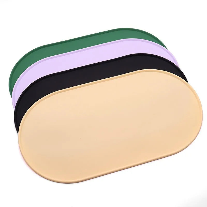 Silicone waterproof placemat for cat food and water bowls in green, beige, black, or purple.