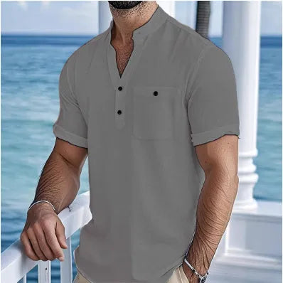 Man's light blue linen blend t-shirt with stand collar and short sleeves in a loose fit.