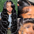 Black medium-long wavy full-head synthetic wig on a mannequin head showing curly texture and lace front detail.