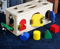 Wooden educational shape sorting box with 12 matching blocks for preschool children