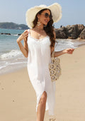 White crocheted beach dress on a hanger, showing hollow weave detail and a side slit.