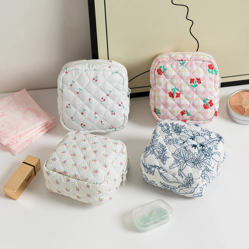 Polyester key storage wallet with floral or cherry print and sewing thread detail.