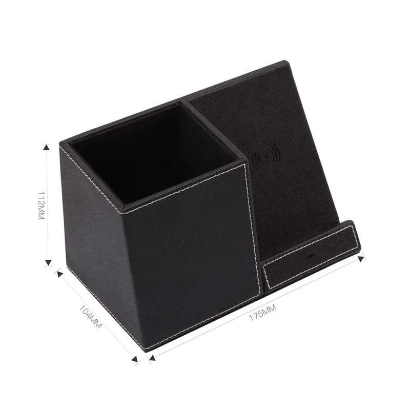 Black leather pen holder with integrated wireless phone charging pad on a desk.