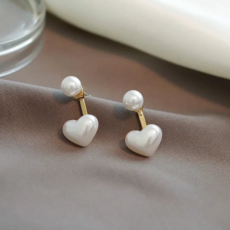 Korean style heart-shaped pearl stud earrings for women with artificial gem inlays on electroplated alloy.