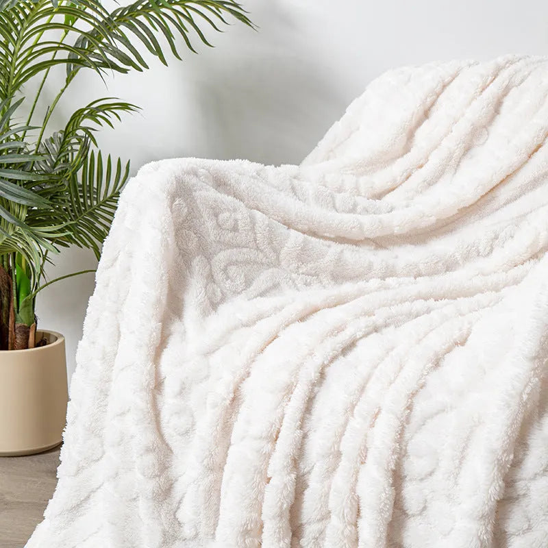 Shu cotton velvet jacquard sofa blanket in a solid colour draped over a modern sofa