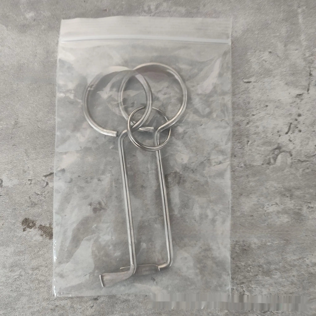 Two alloy wrench tools from a portable family maintenance set on a plain background.