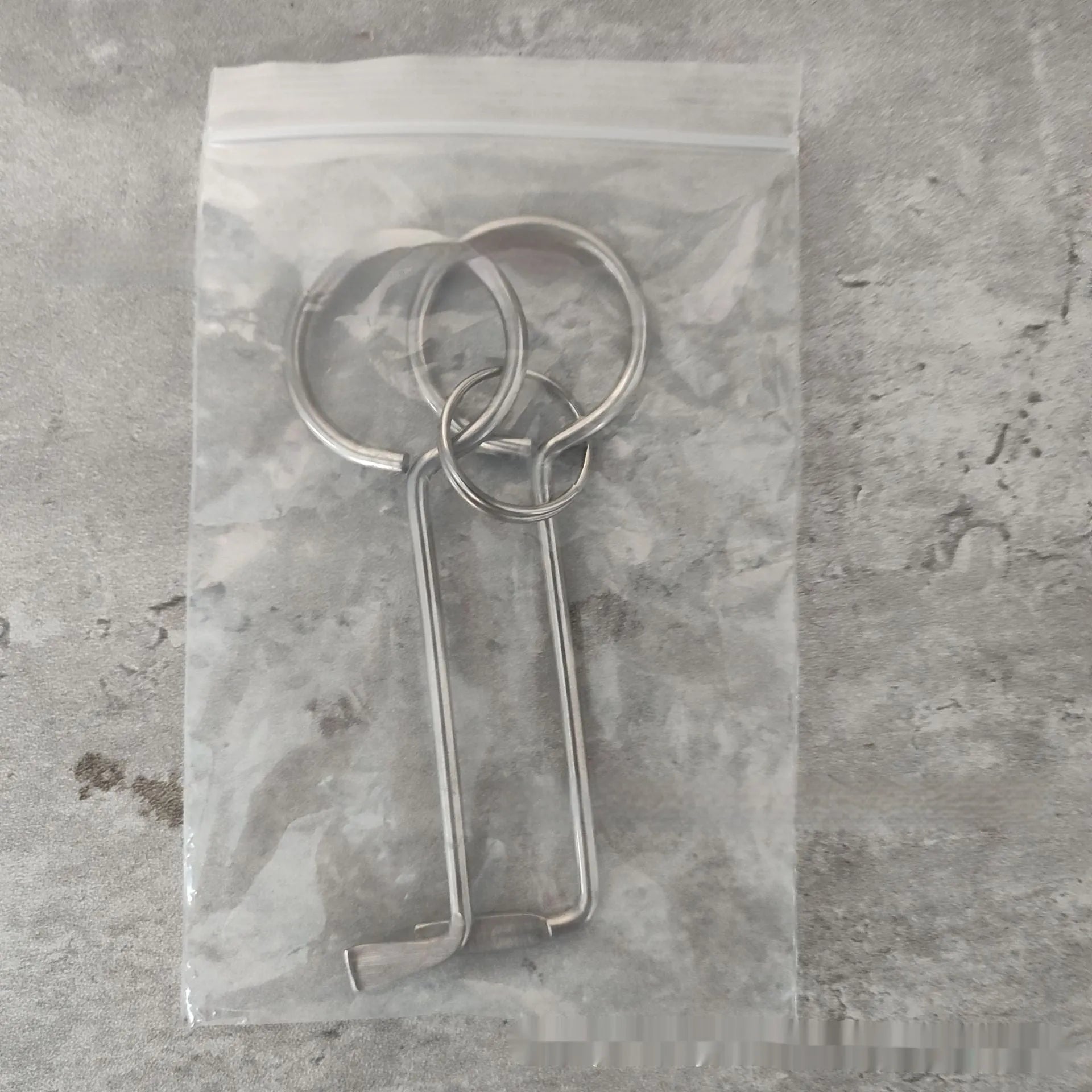 Two alloy wrench tools from a portable family maintenance set on a plain background.