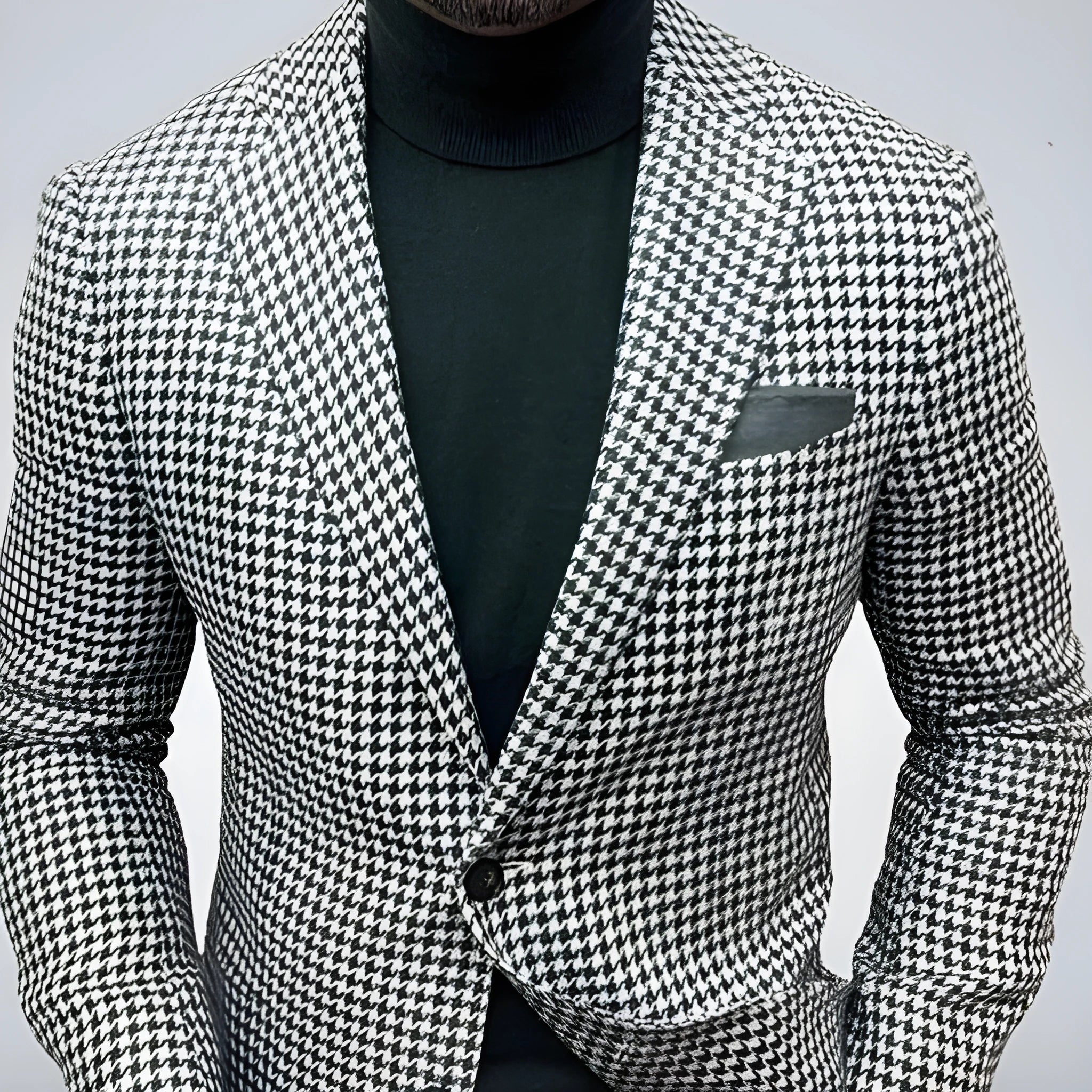 Men's slim-fit two-button suit jacket in a British style with large top-stitch pockets.