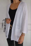 Women's army green waffle knit cardigan coat with nine-quarter sleeves and pockets.