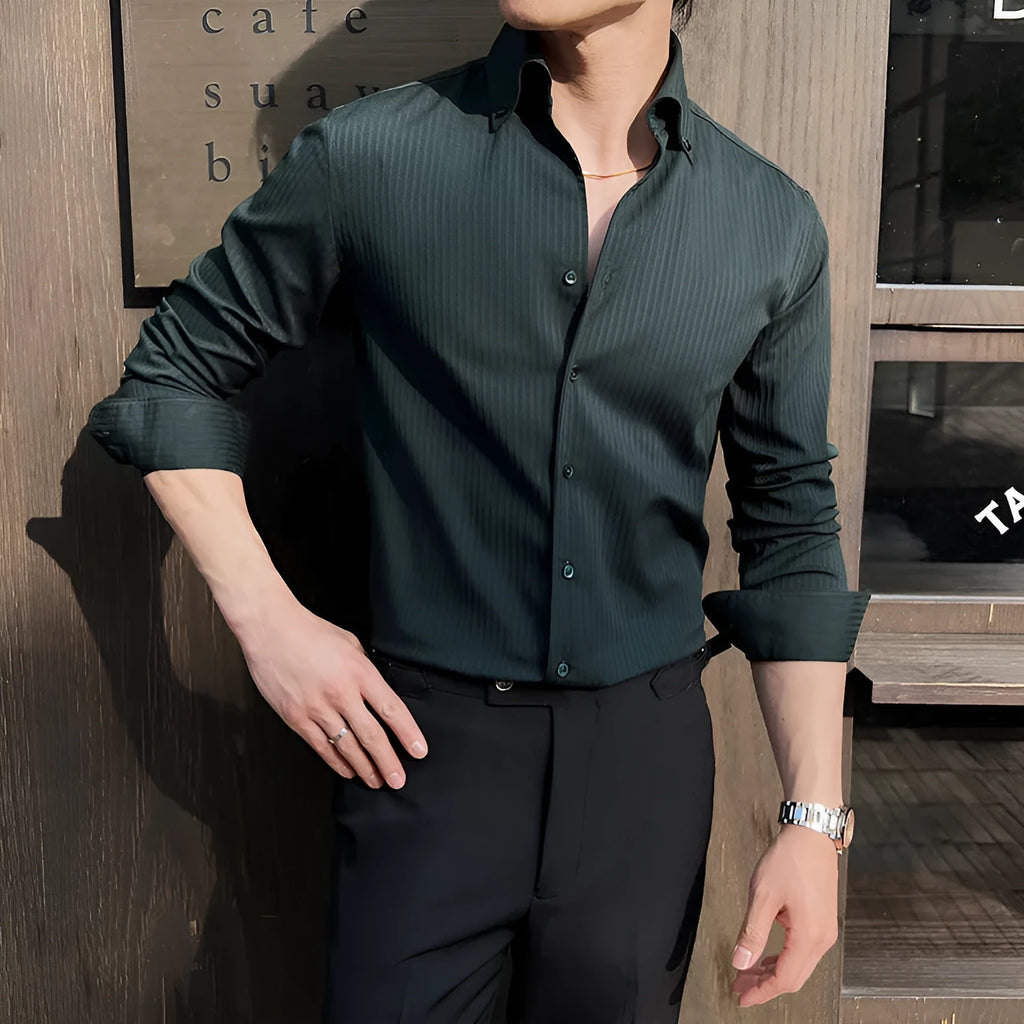 Man wearing a dark striped V-neck long sleeve shirt in a cardigan style.