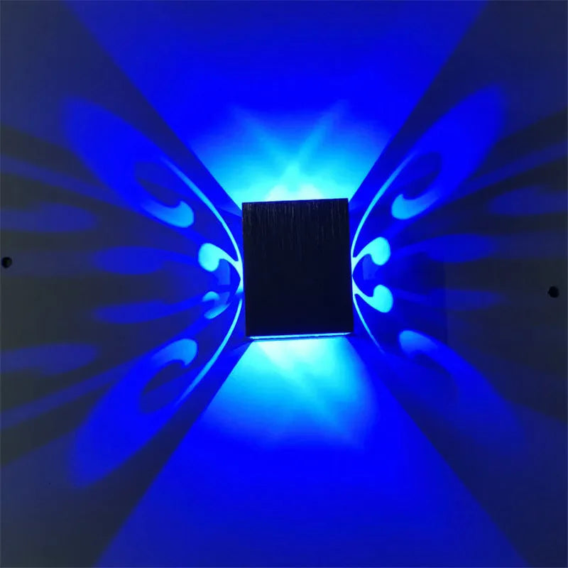 Modern aluminium butterfly-shaped LED wall lamp with remote control for changing light colours.