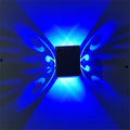 Modern aluminium butterfly-shaped LED wall lamp with remote control for changing light colours.