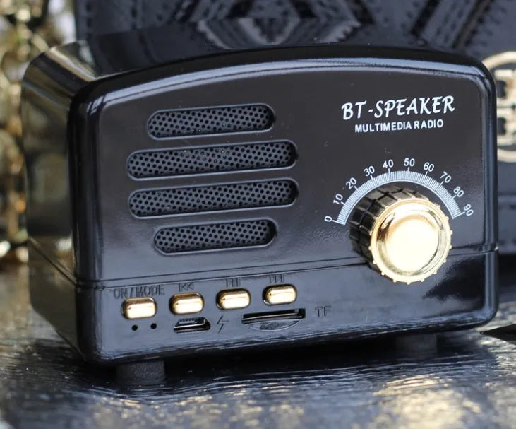 Vintage style Bluetooth speaker in wood grain finish showing front grille and compact size.