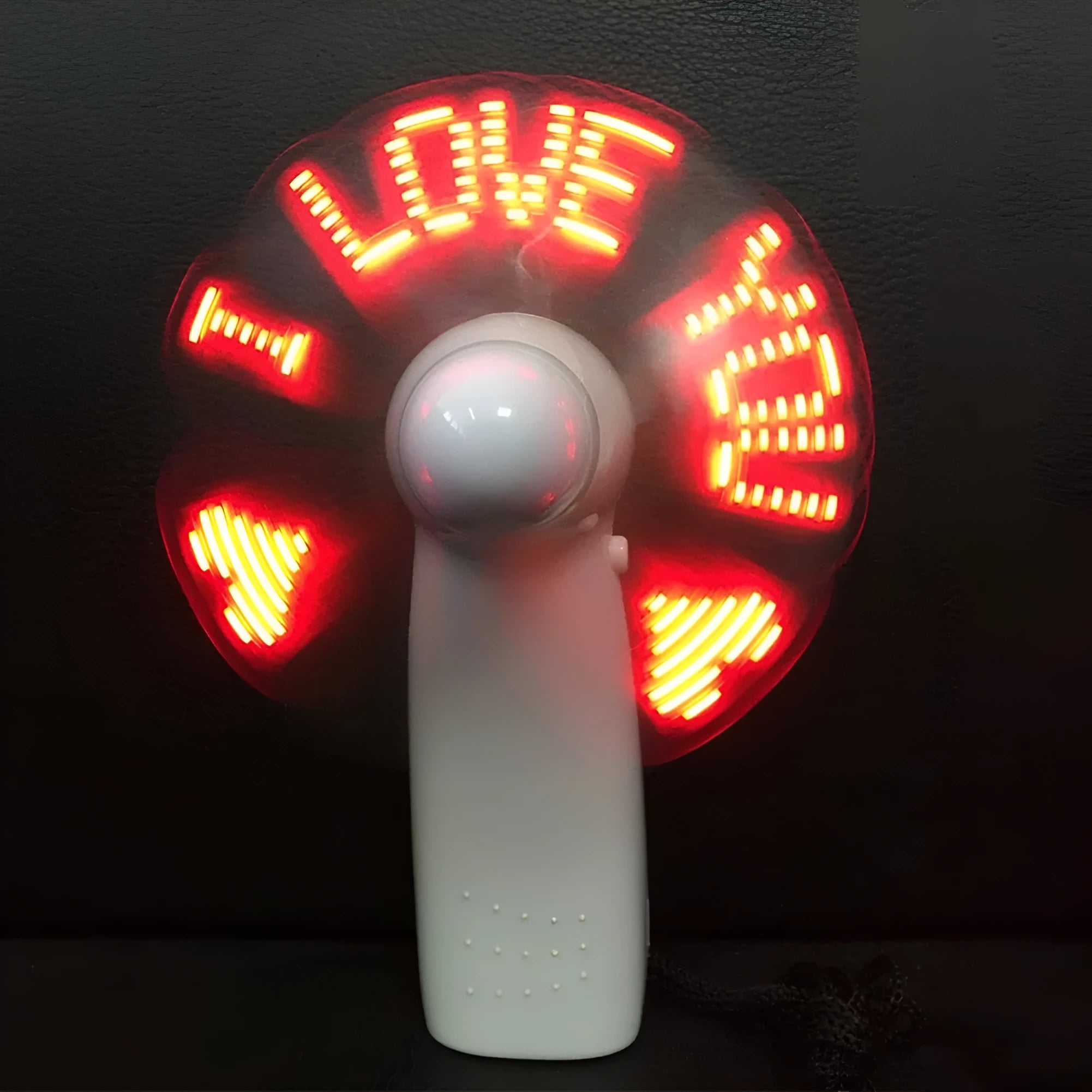 White handheld mini fan showing blue and red LED lights forming a heart and 'I love you' message.