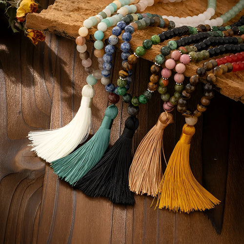 Long Bohemian necklace with geometric stone beads and tassel, plus matching bracelet, shown in an electroplated colour.