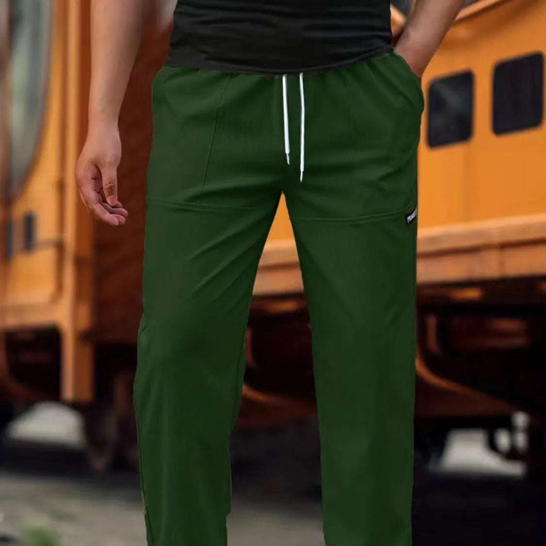 Men's polyester trousers in light grey, shown flat, with a size label indicating S-XXXL range.