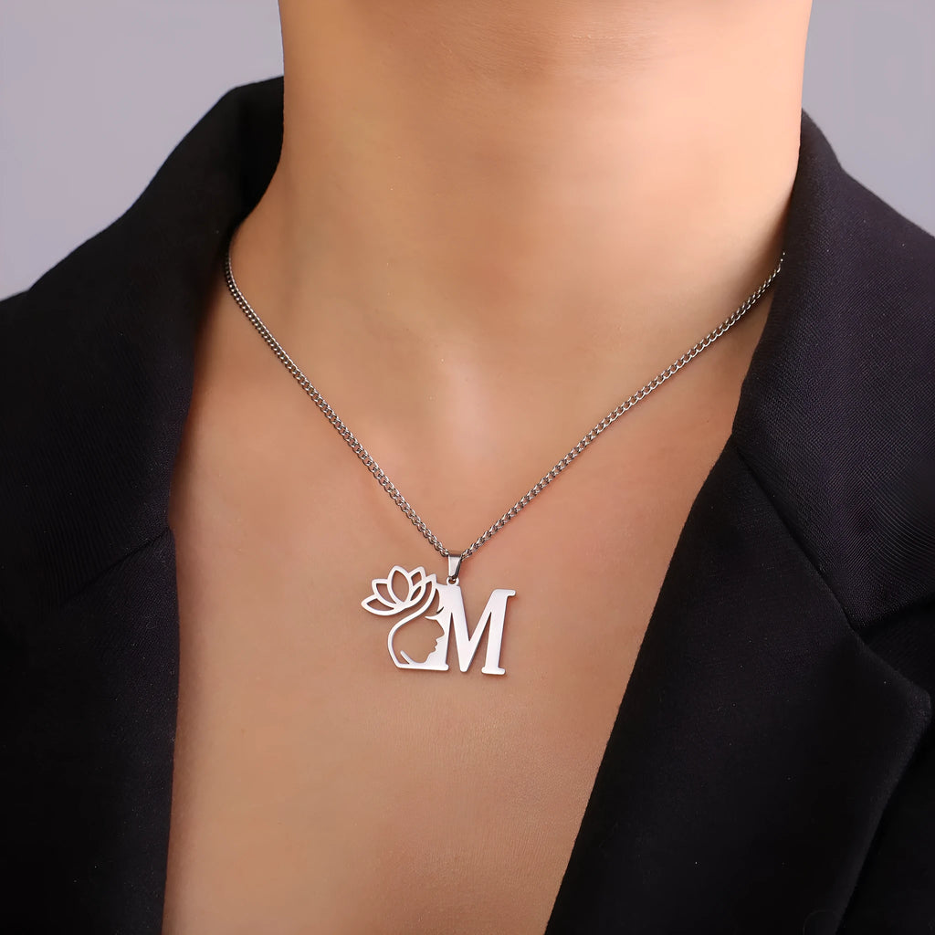 Stainless steel letter necklace with cross chain and single initial pendant in gold tone.