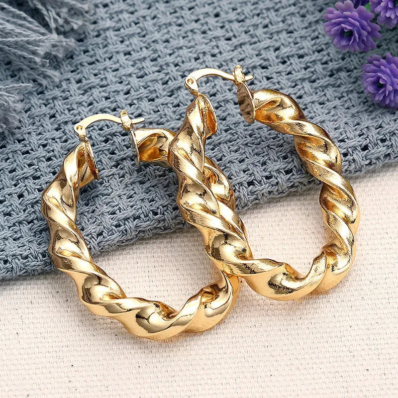Geometric ring design drop-shaped ear clip earrings for women in a metallic electroplated finish.