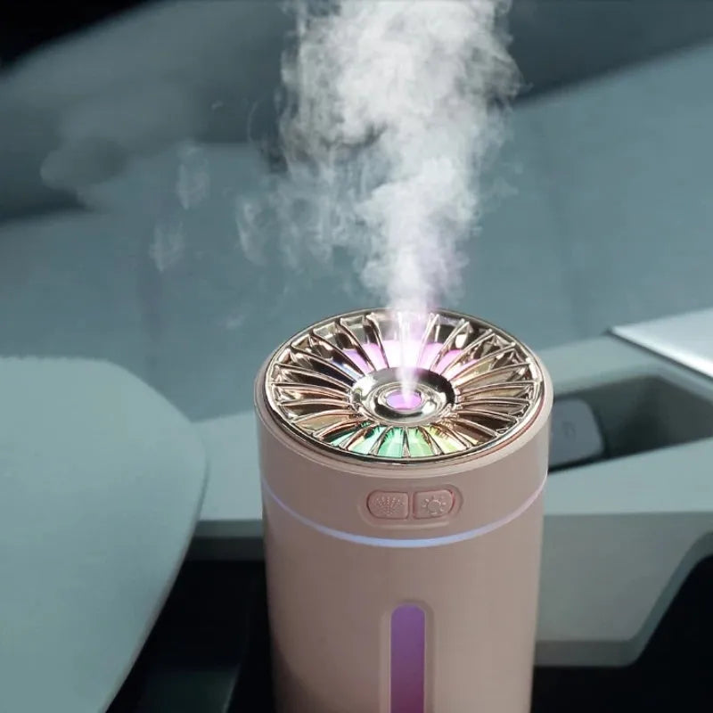 Black portable USB humidifier with colourful LED lights, shown next to a USB cable, suitable for car cup holders.