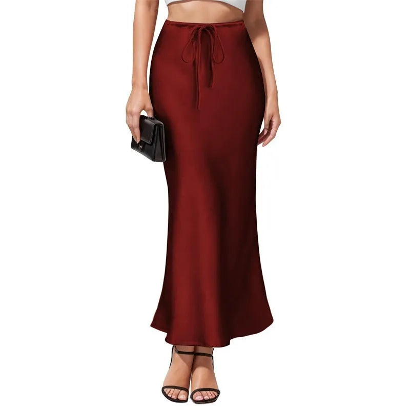 High-waisted acetate satin asymmetric skirt in a solid colour on a model