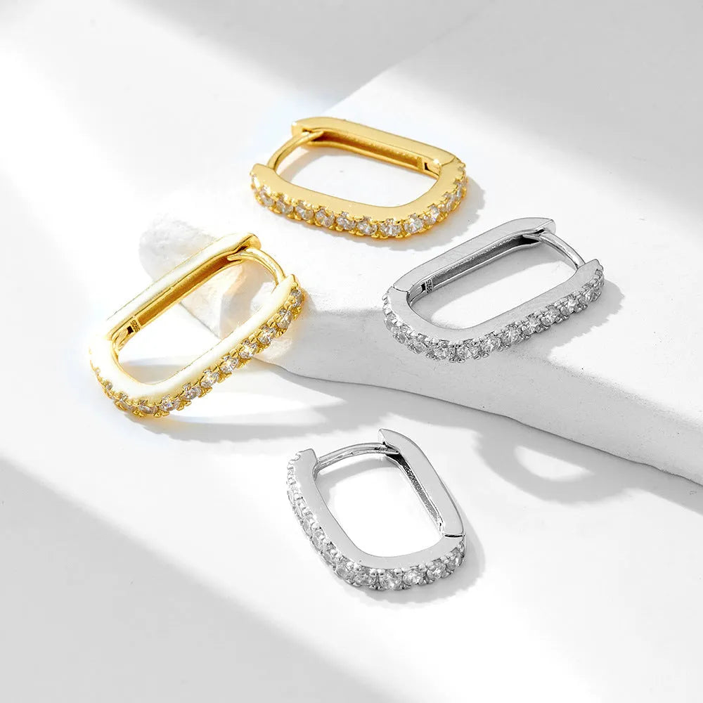 Sterling silver oval zircon ear clips with geometric design in yellow or white silver finishes