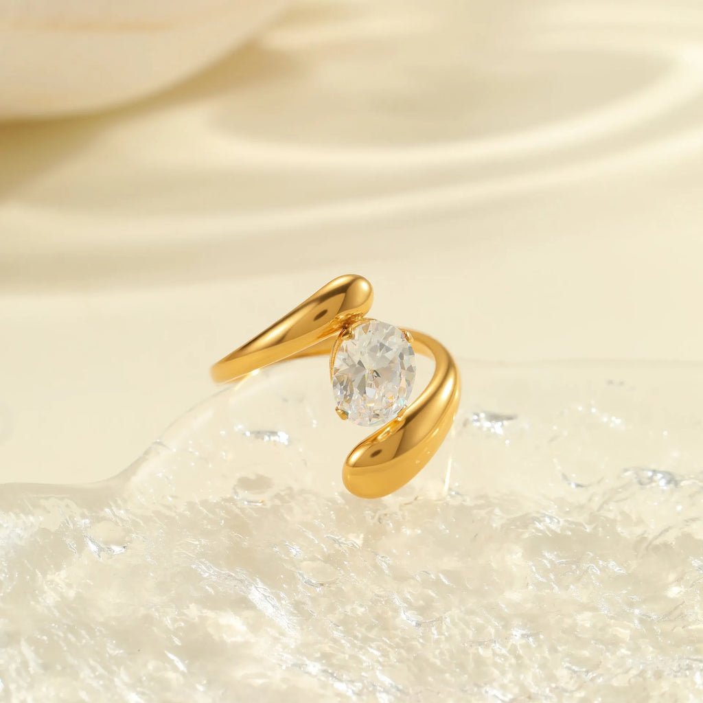 Geometric stainless steel open mouth ring with zircon detail and electroplated finish.