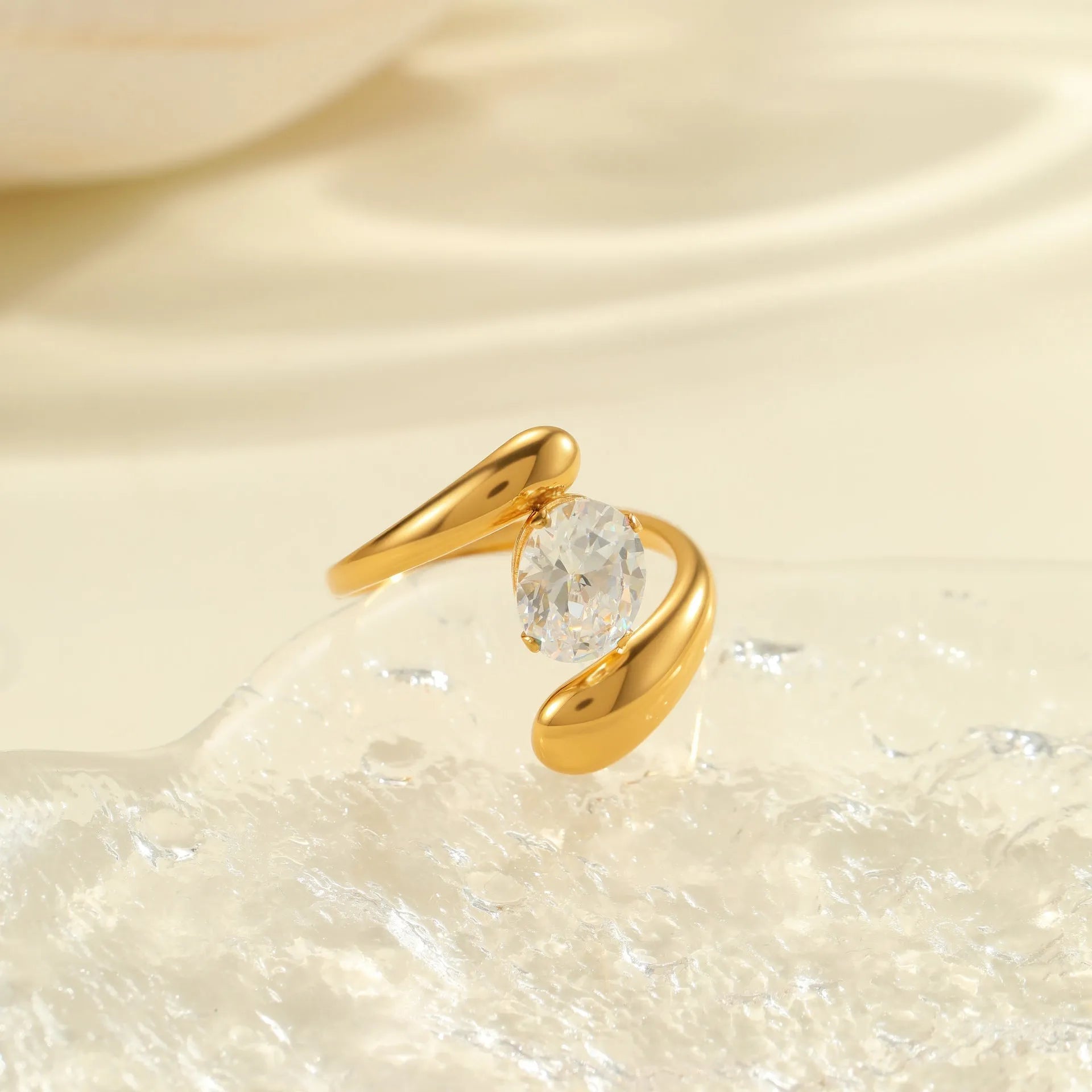 Geometric stainless steel open mouth ring with zircon detail and electroplated finish.