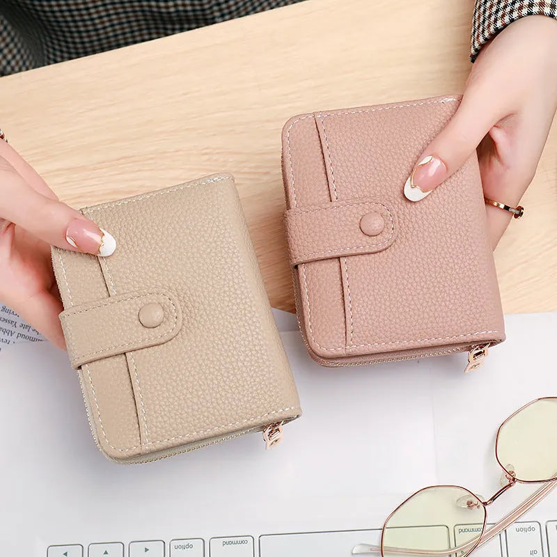 Ladies short wallet in PU leather with a lychee pattern, shown folded, in beige, pink, black, and red colour options.