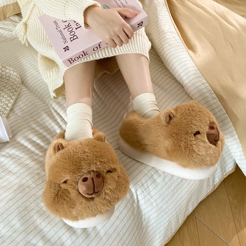 Light brown women's winter slippers with plush cotton upper and cartoon pattern.