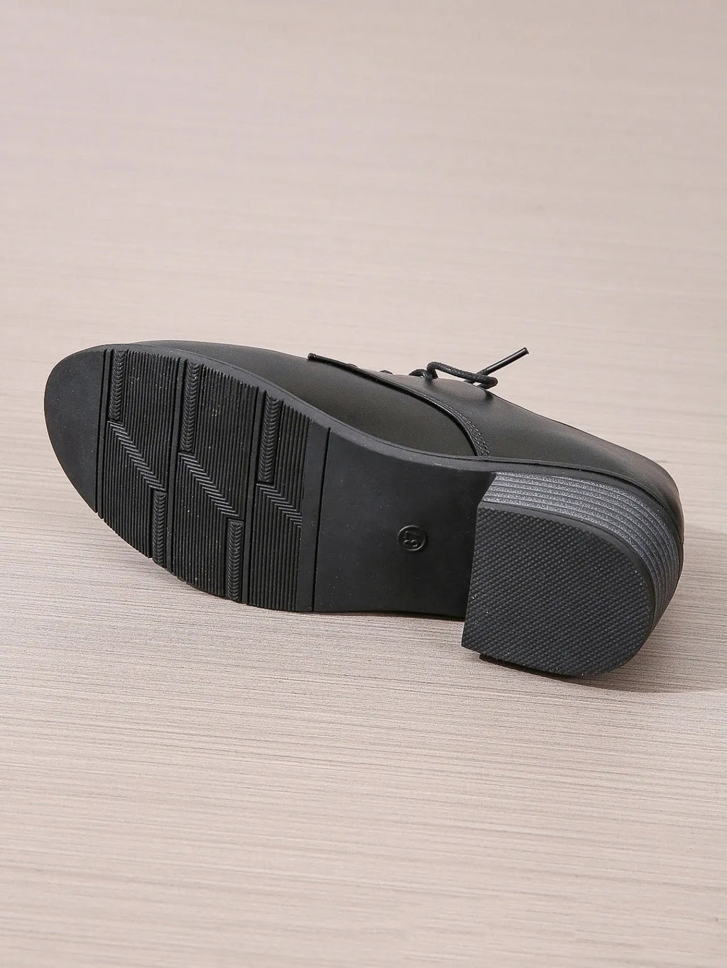 Black women's low-top work shoes with a chunky heel and pointed toe.