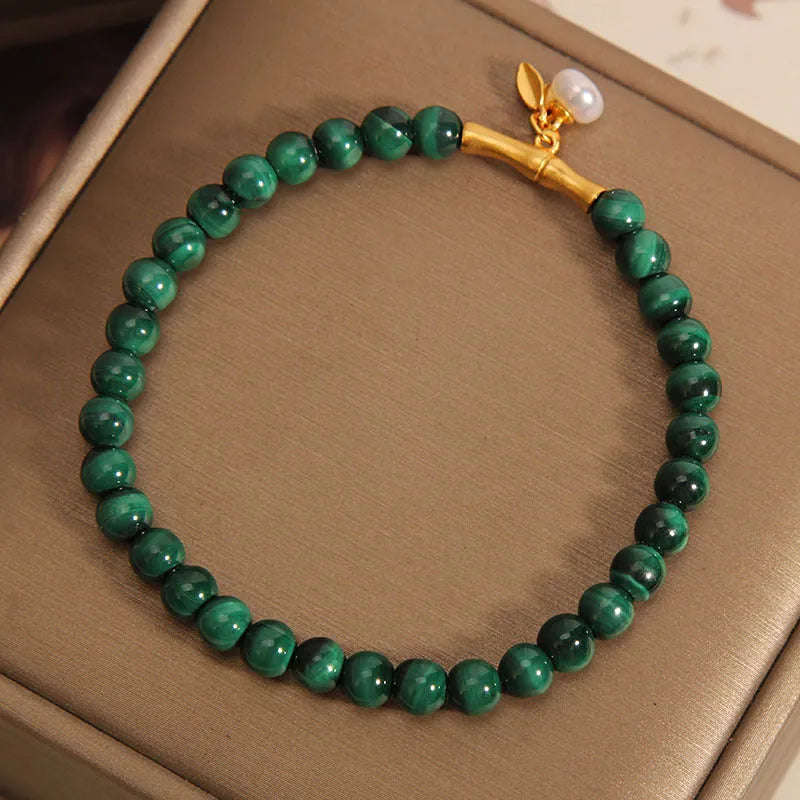 Women's white crystal bracelet with bamboo charm on adjustable metallic chain showing length between 20-24cm