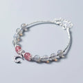 Handmade adjustable moonstone bracelet with silver crescent moon charm and crystal bead on a wrist.