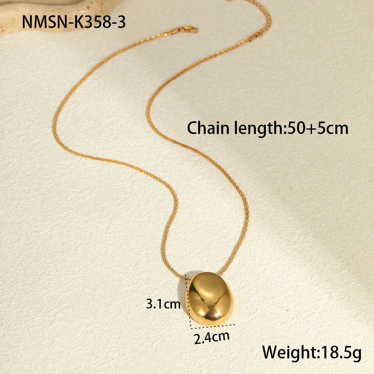 Gold geometric pendant necklace with adjustable chain on jewellery display