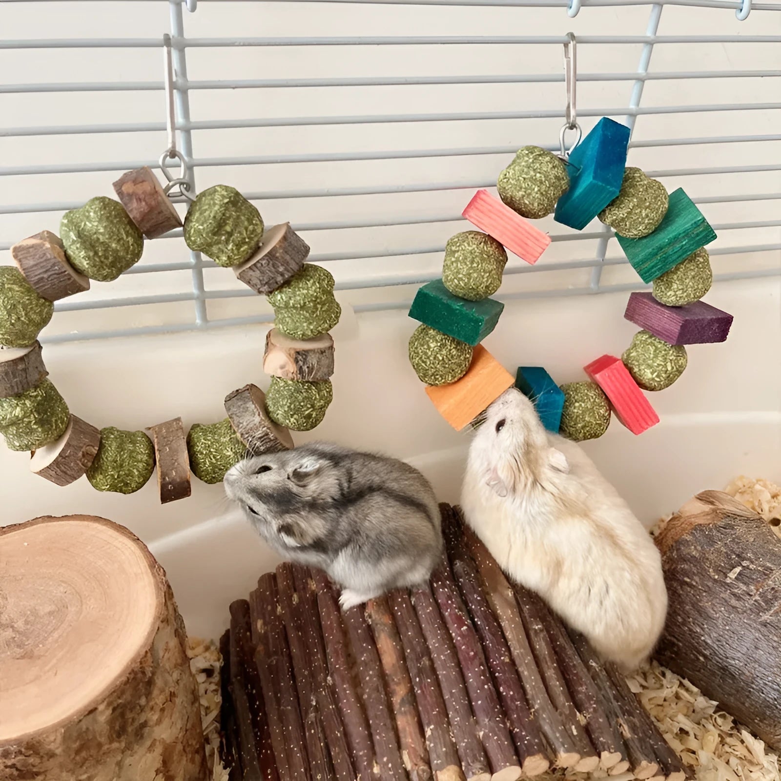Decorative straw ball ring chew toy for small pets like hamsters, shown in sequin and applewood designs.