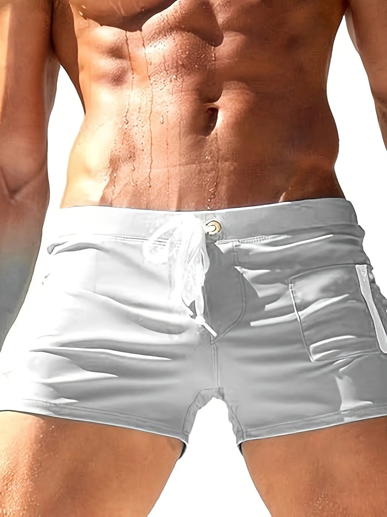 Men's high-waist lace-up polyester swimming trunks in solid colour on mannequin.