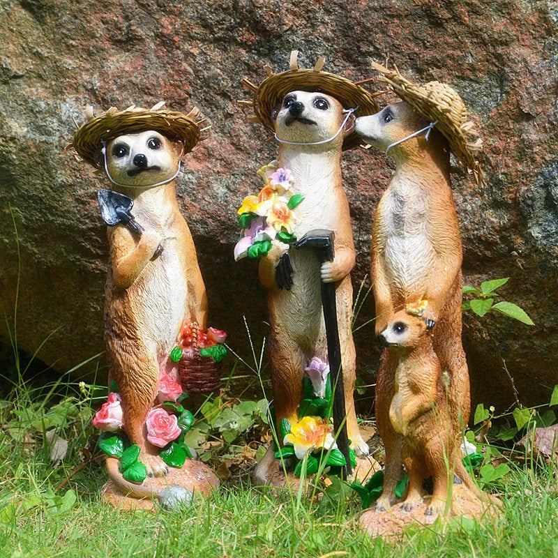 Yellow brown synthetic resin mongoose garden ornament wearing a straw hat and holding a rake or shovel for bonsai decoration