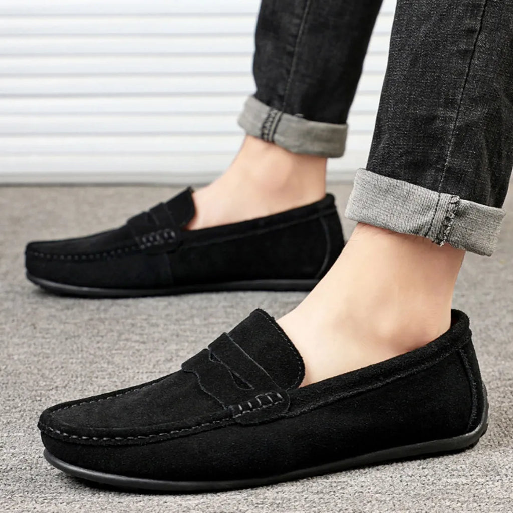Men's solid colour suede leather slip-on loafers with round toe and flat rubber sole.