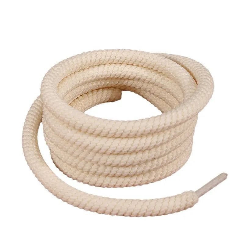 Round 10mm diameter woven shoelaces in white, beige and black colours showing thickness variations