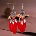 Feather-shaped round drop alloy earrings with leaf design in electroplated finish, showing Bohemian style jewellery.