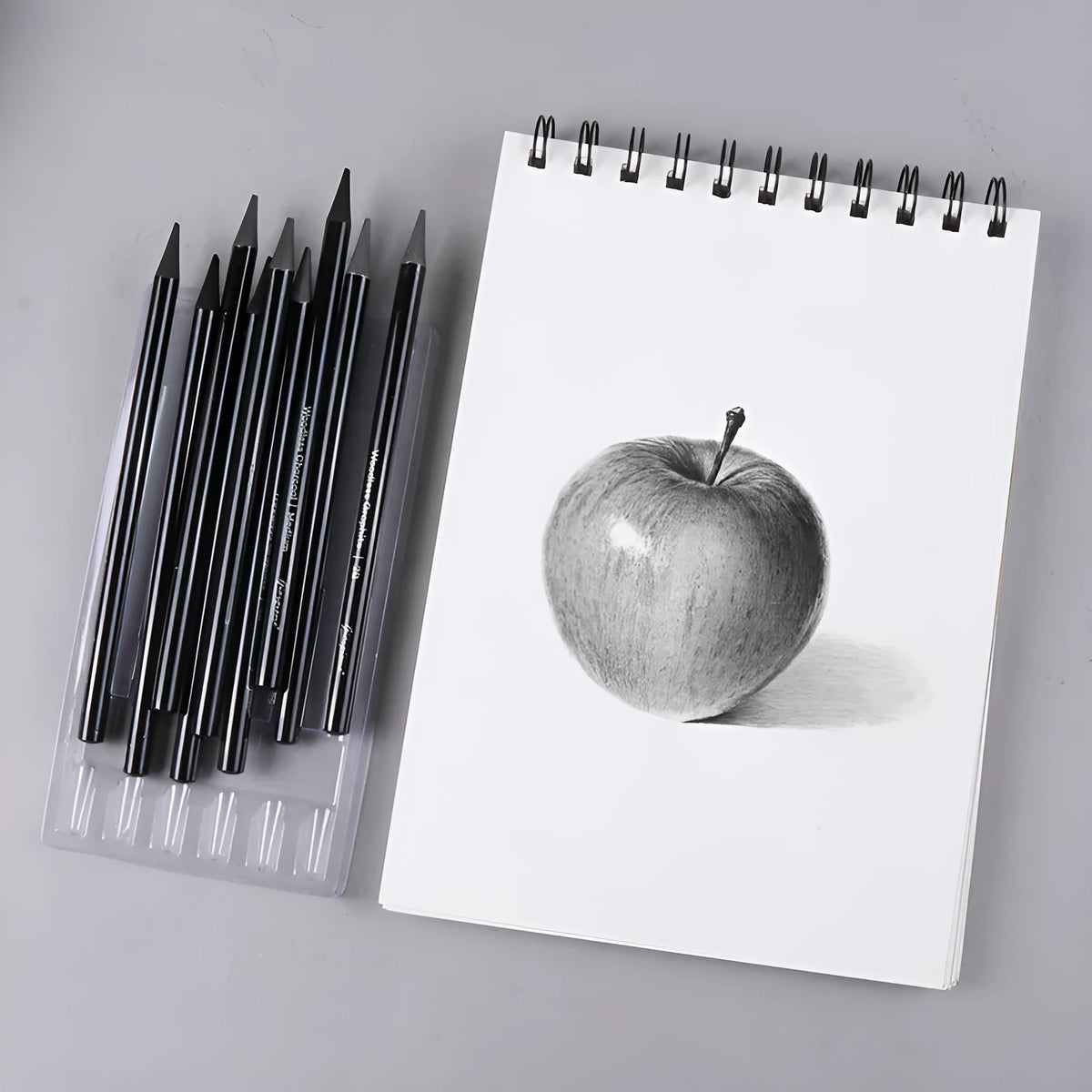 Carbonized and graphite pencil suit with nine wooden pencils on a suction card packaging