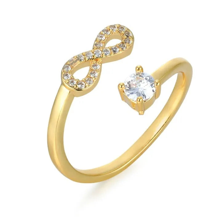 Open geometric metal ring with a centred zircon stone, displaying a personalised initial, in gold finish.